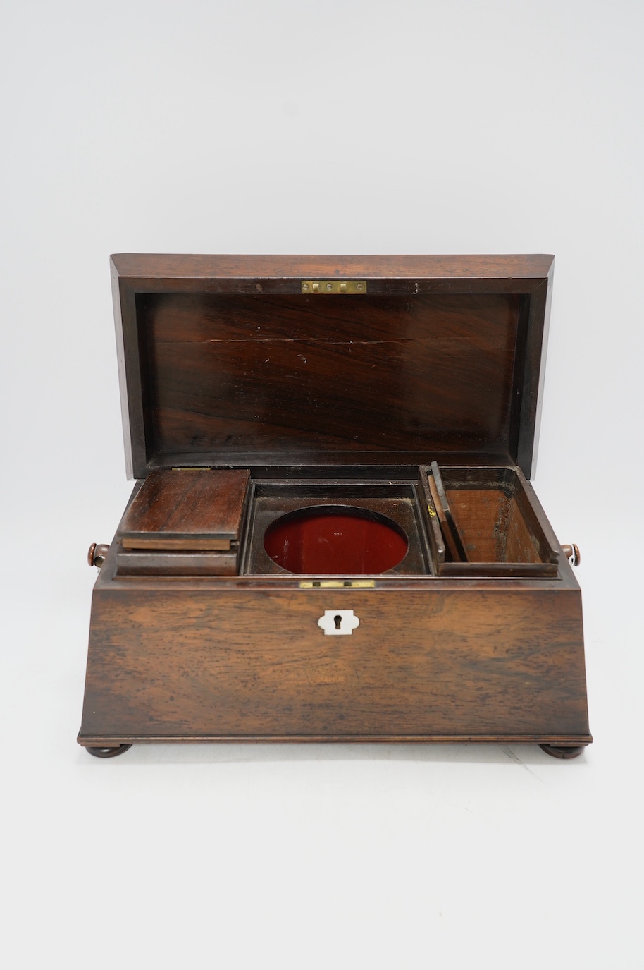 A Victorian rosewood sarcophagus shaped tea caddy with mother of pearl escutcheon, 33.5cm wide. Condition - fair, some internal damage